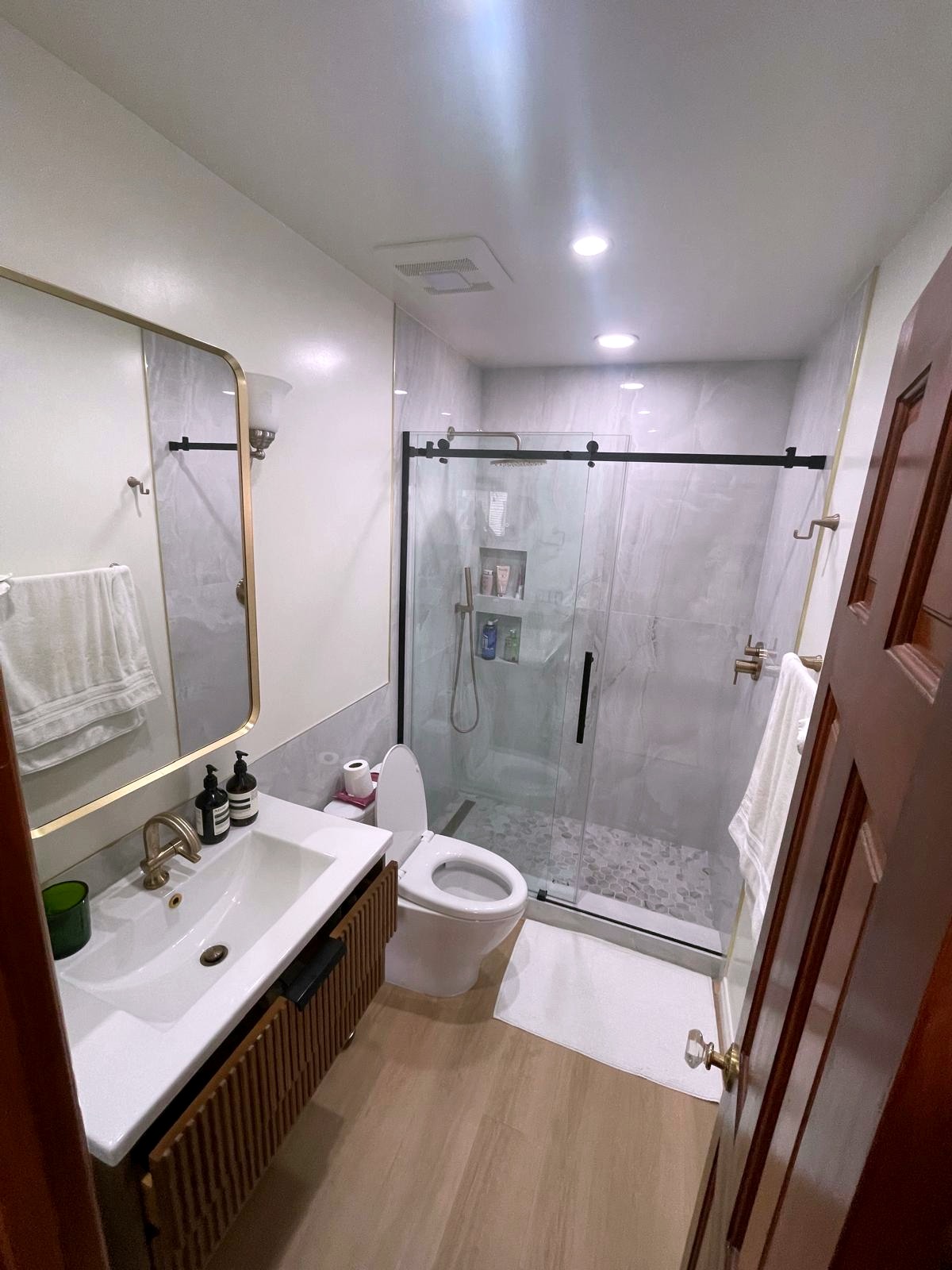 Remodeled bathroom with walk-in glass shower — Santa Monica