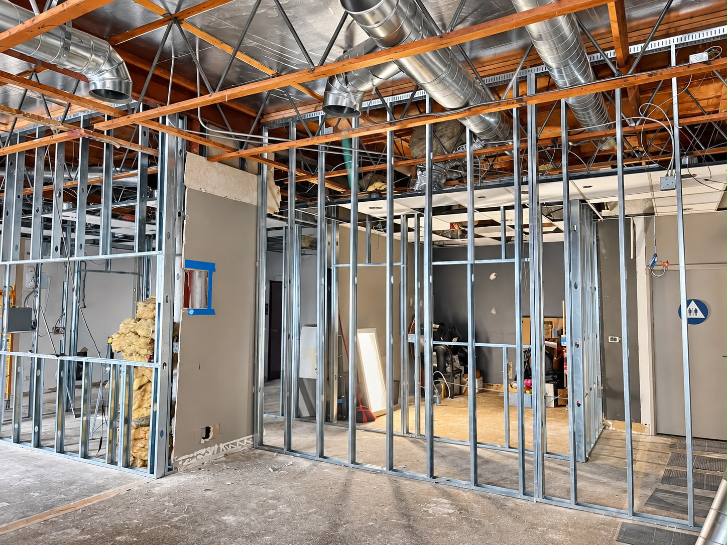 Commercial store remodel mid-construction, exposed steel-stud framing — Hollywood, California