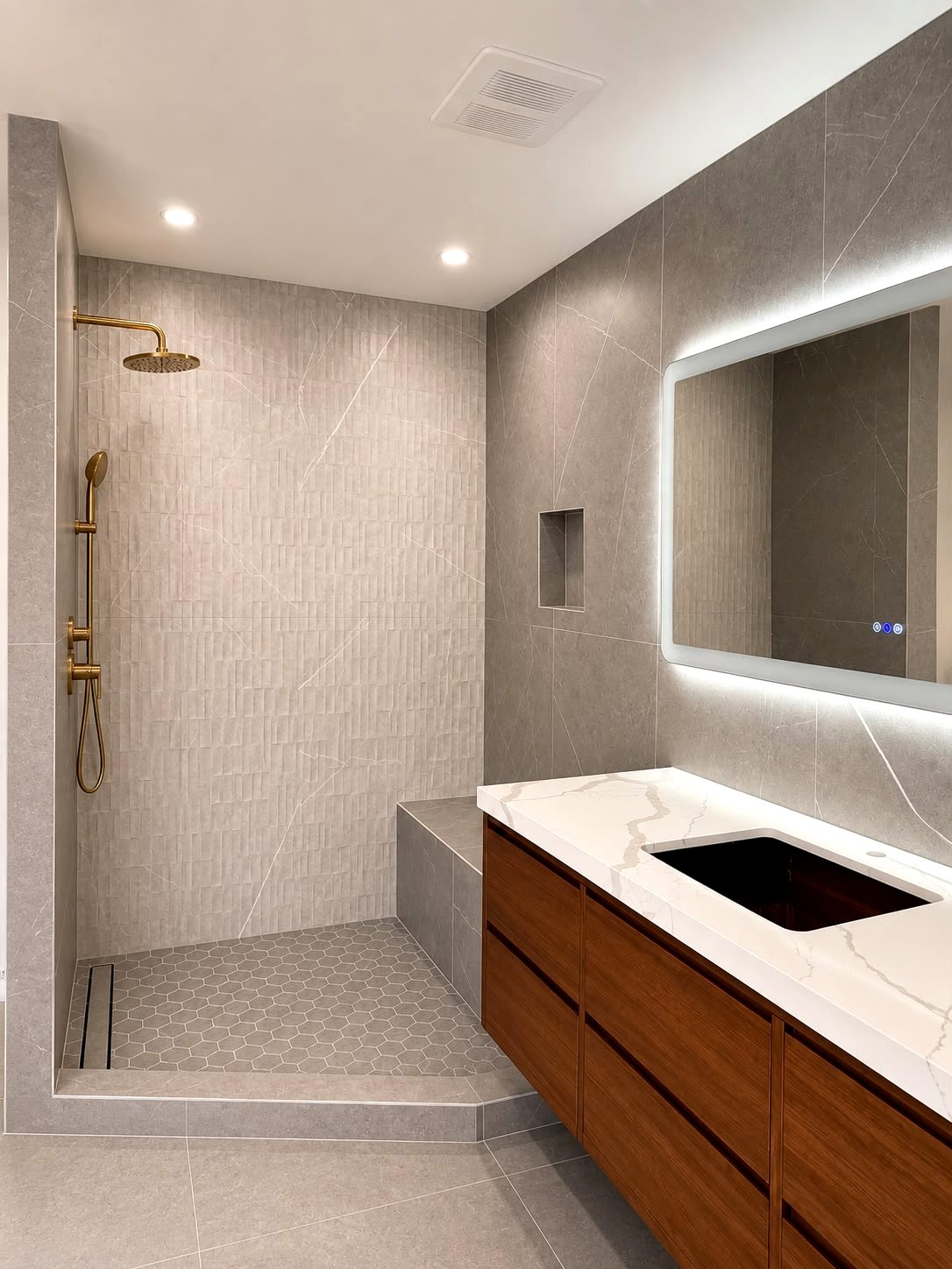 Modern bathroom remodel with floating wood vanity and backlit mirror — Los Angeles